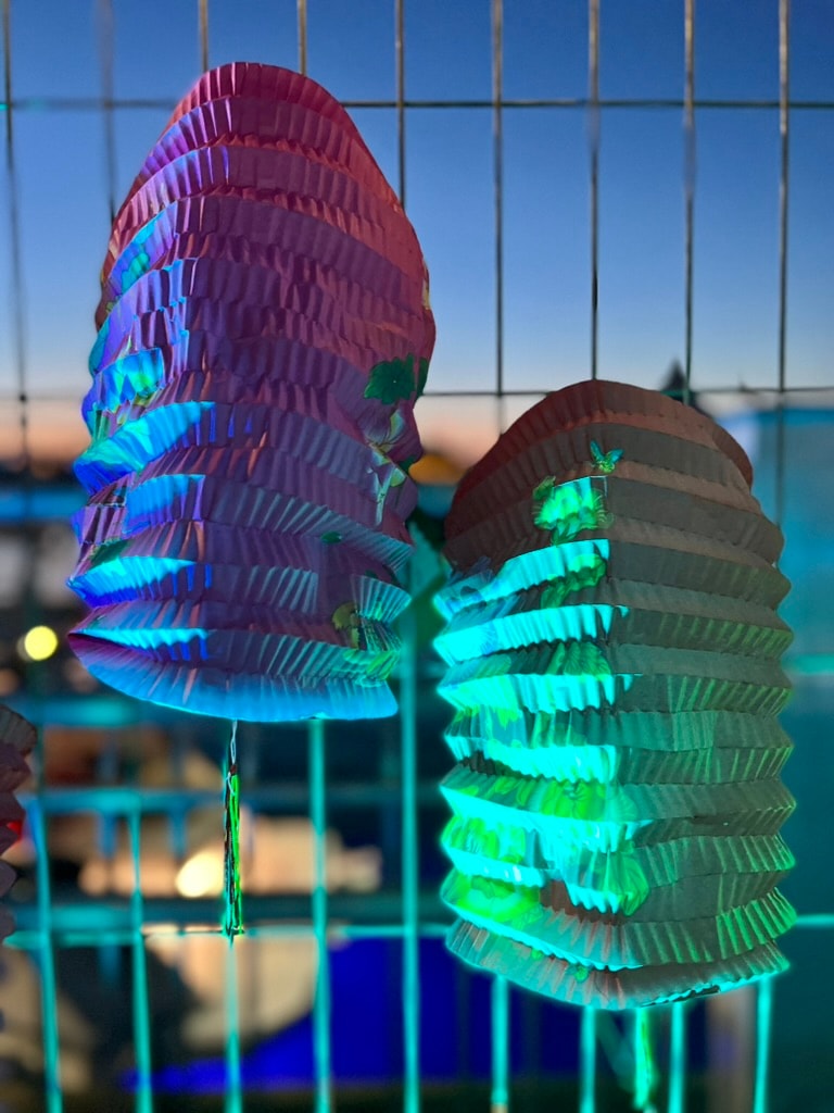 Emblem design for Madame FC depicting an M monogram in a circle with the words "Madame FC EST. 2003" inside on top of a background image of a soccer stadium.